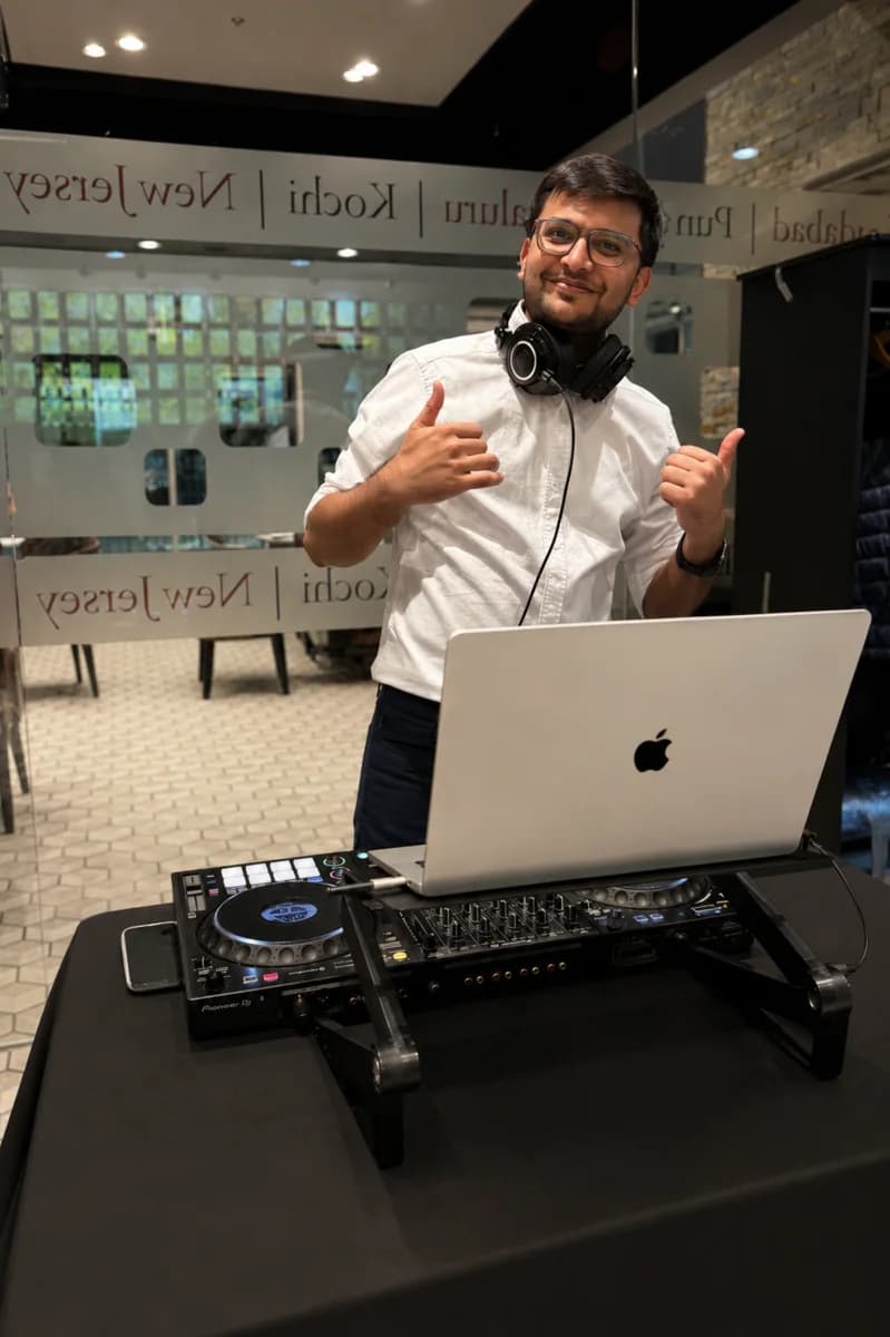 DJ H3T smiling behind a professional DJ setup